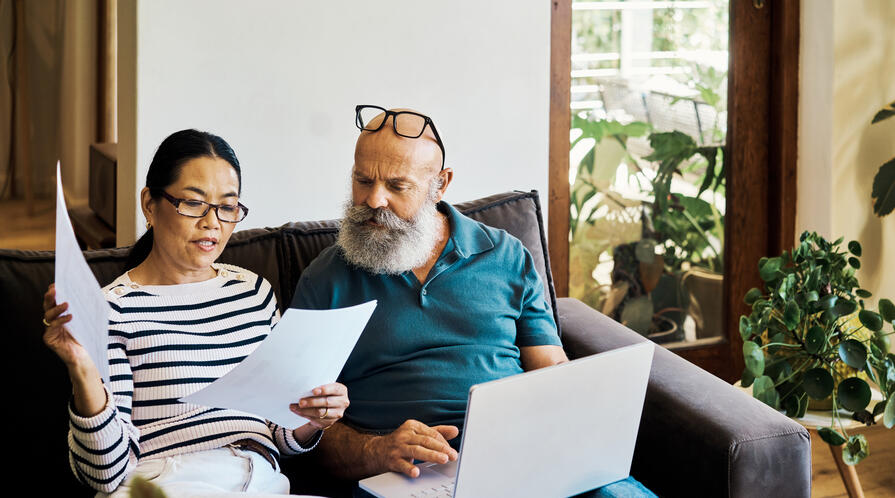 Couple looks at bills with concern
