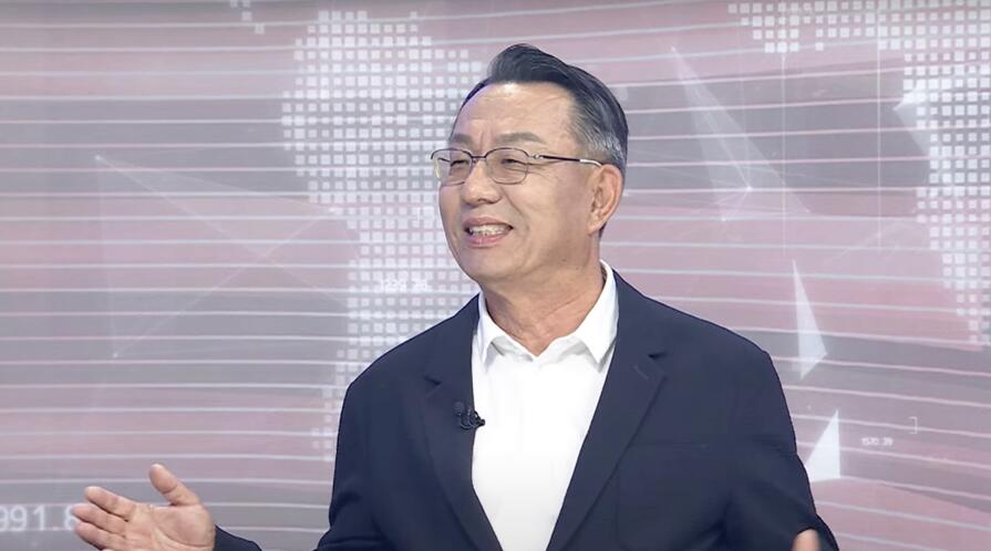 Gi-Wook Shin in a TV studio, speaking during an interview with Arirang TV.