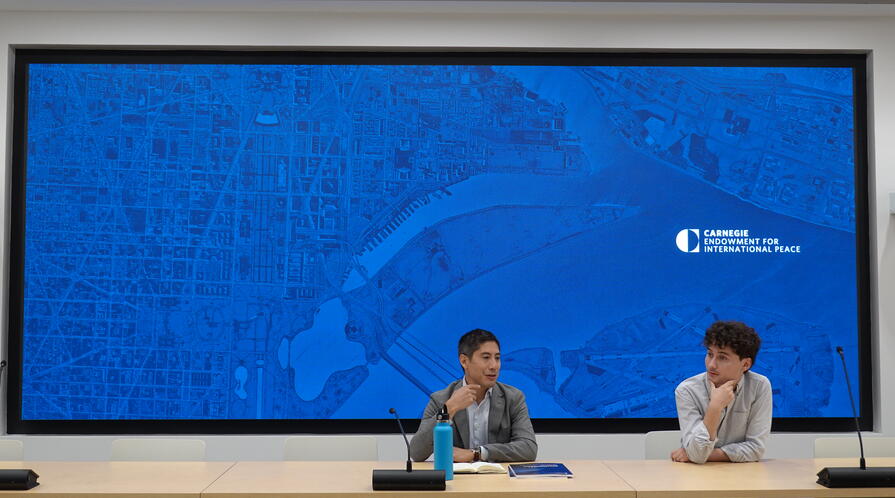 Steve Feldstein and Adrian Feinberg, '25, present to the group at the Carnegie Endowment for International Peace.