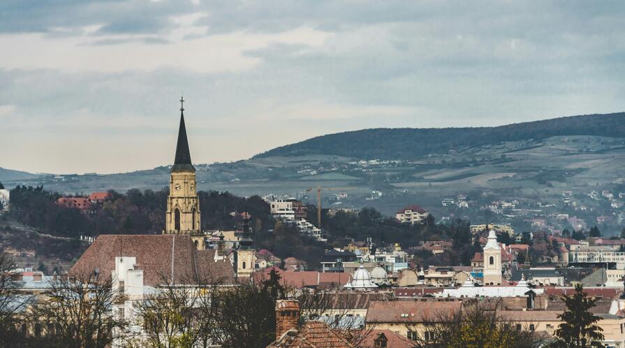 Brown and white concrete building under white clouds during daytime