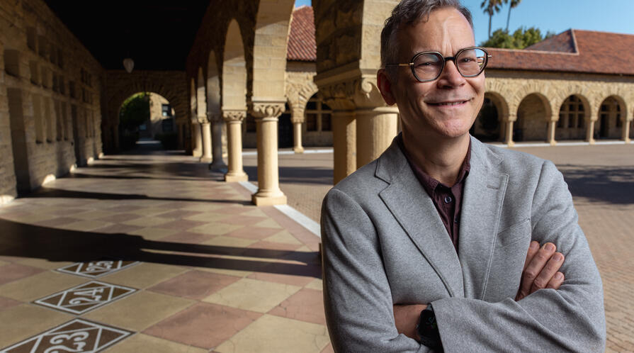 Colin H. Kahl under the arches of Stanford's main quad
