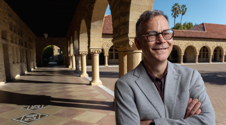 Colin H. Kahl under the arches of Stanford's main quad