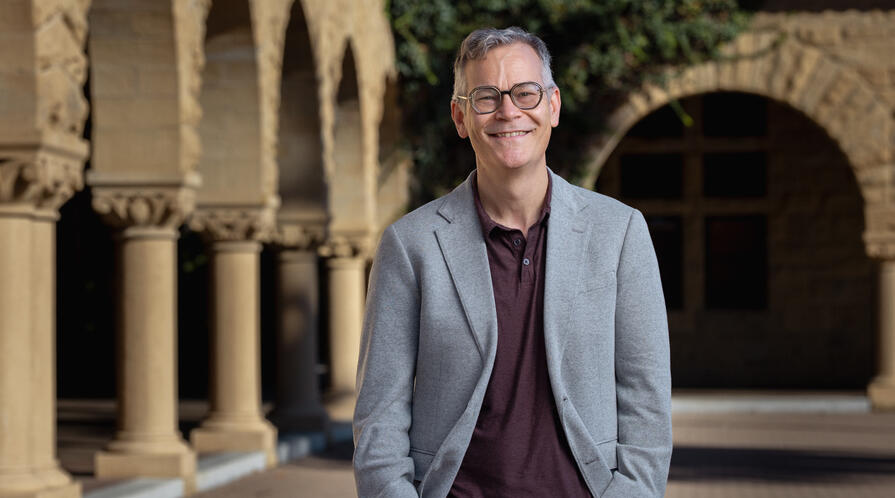 Colin H. Kahl standing in Stanford's main quad