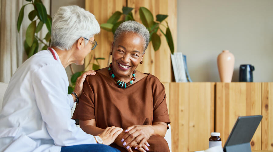 An elderly physician and patient