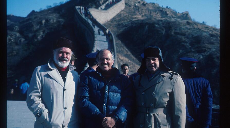 three people standing at the great wall in China