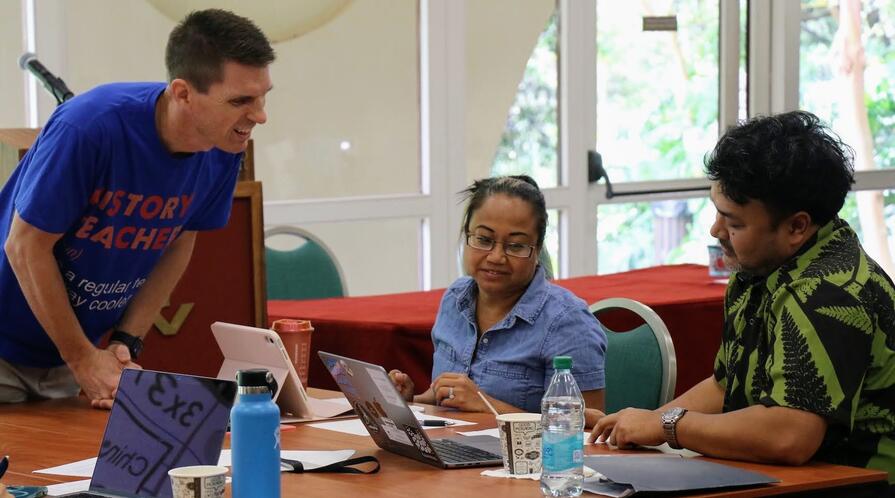 three teachers working on an activity around a table