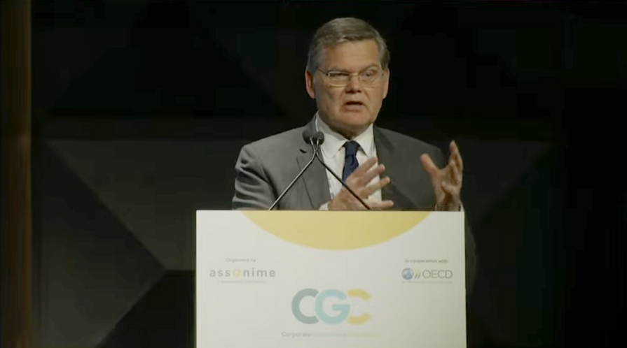 Curtis Milhaupt delivers a speech at a podium.