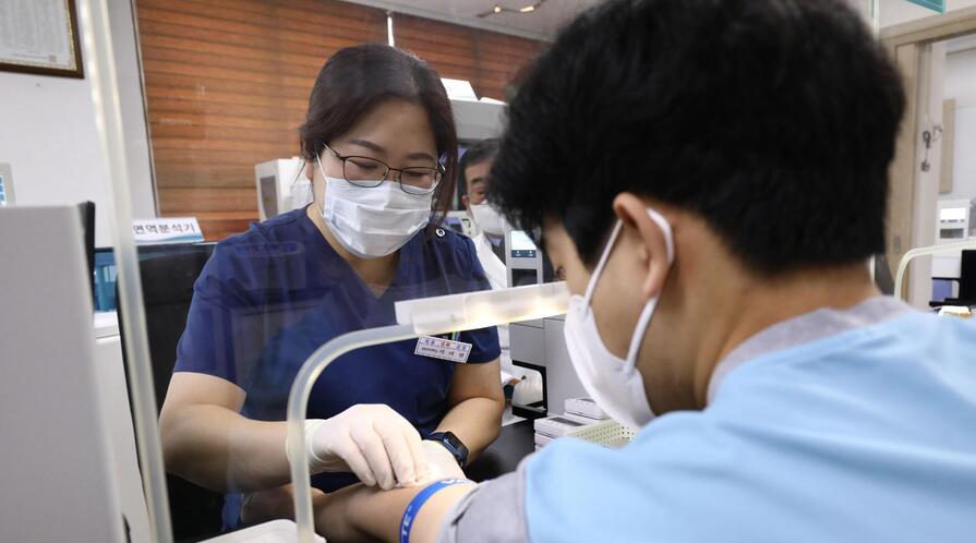 A teenager is given blood test during a physical examination in Seoul, South Korea.