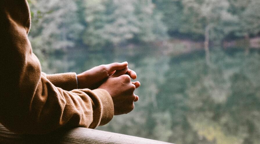 A photo of a person overlooking water