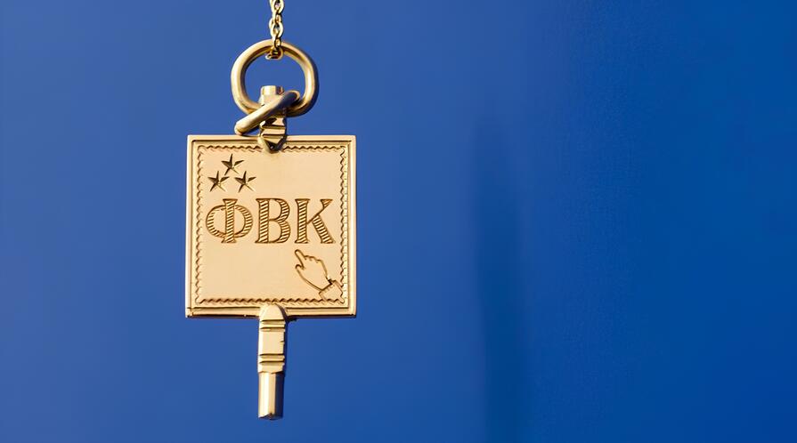 Hanging gold charm with greek letters "Phi Beta Kappa" on blue background