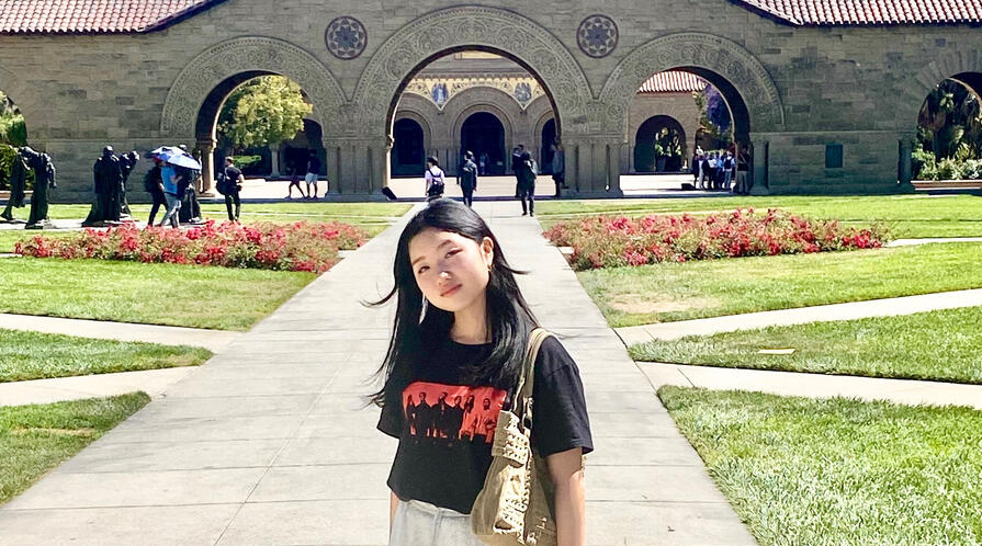 a student in front of Memorial Church during a summer program at Stanford University