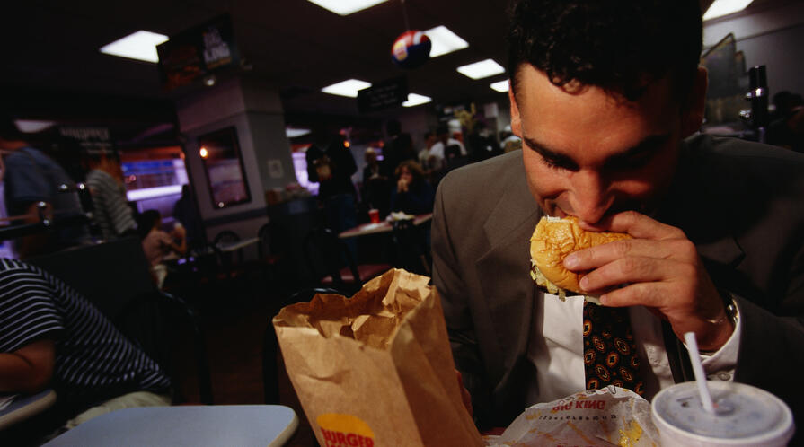 A man eating a hamburger at Burger King