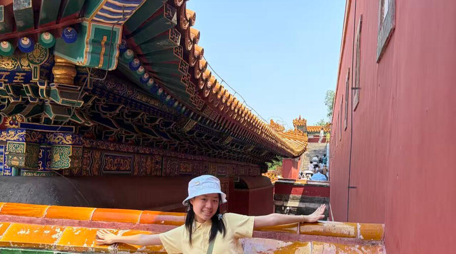 a student standing in front of a building