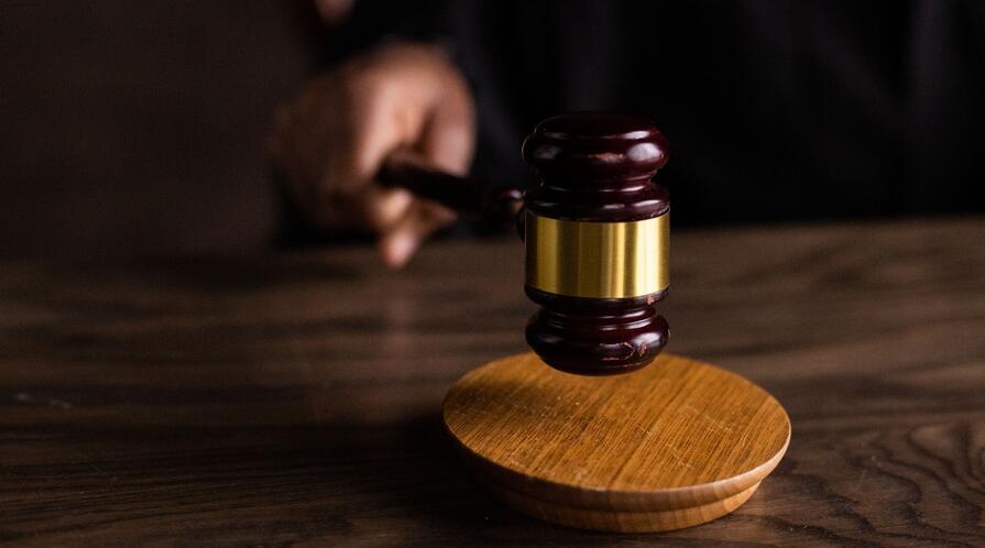 Brown wooden gavel on brown wooden table