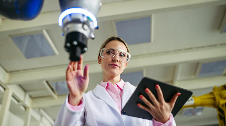 A woman doctor or engineer at a medical device and tablet