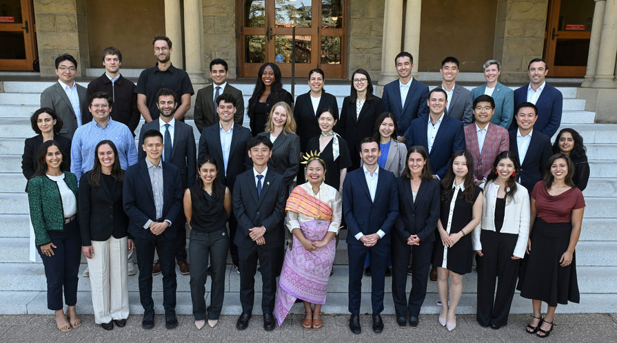 A group photo of the Class of 2028 of the Ford Dorsey Master's in International Policy on the front steps of Encina Hall at Stanford University.