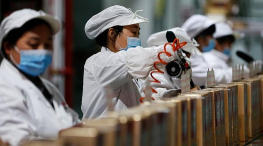 Workers on the assembly line in the packaging workshop of a liquor enterprise, Sihong county, Jiangsu province, China.