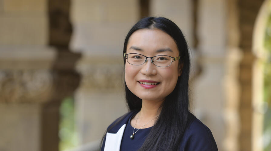 Ketian Zhang standin under Encina Hall arcade