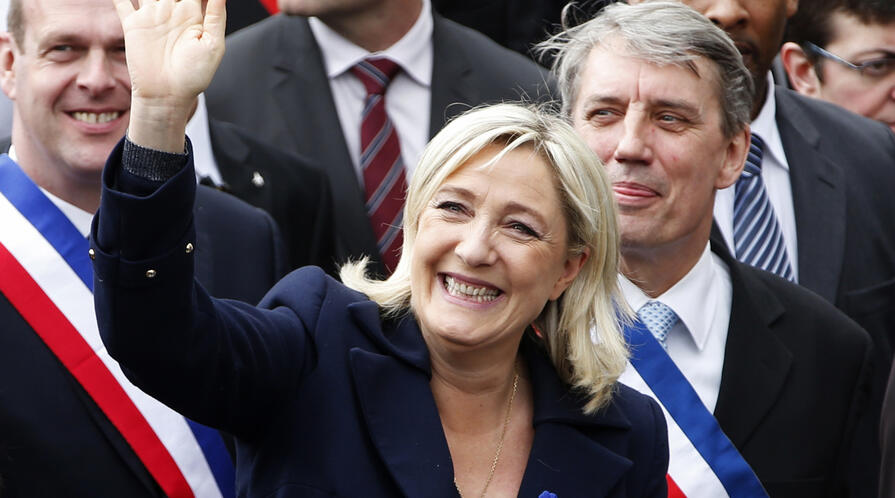 Image of Marine Le Pen (front) waving at supporters during gthe National Front's annual May Day rally in Paris May 1, 2014