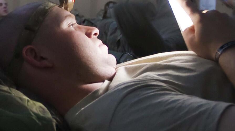 Soldier reading afghanistan logo2