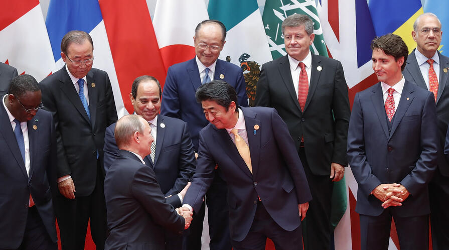 Japanese Prime Minister Shinzo Abe shakes hands with Russian President Vladimir Putin at the G20 Summit on Sept. 4, 2016, Hangzhou, China. | Photo credit: Lintao Zhang/Getty Images