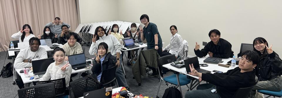 group of students posing in a classroom